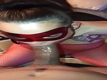 Hooded stunner is dressed in a crimson, fishnet costume while providing a deep throat to a insatiable stranger